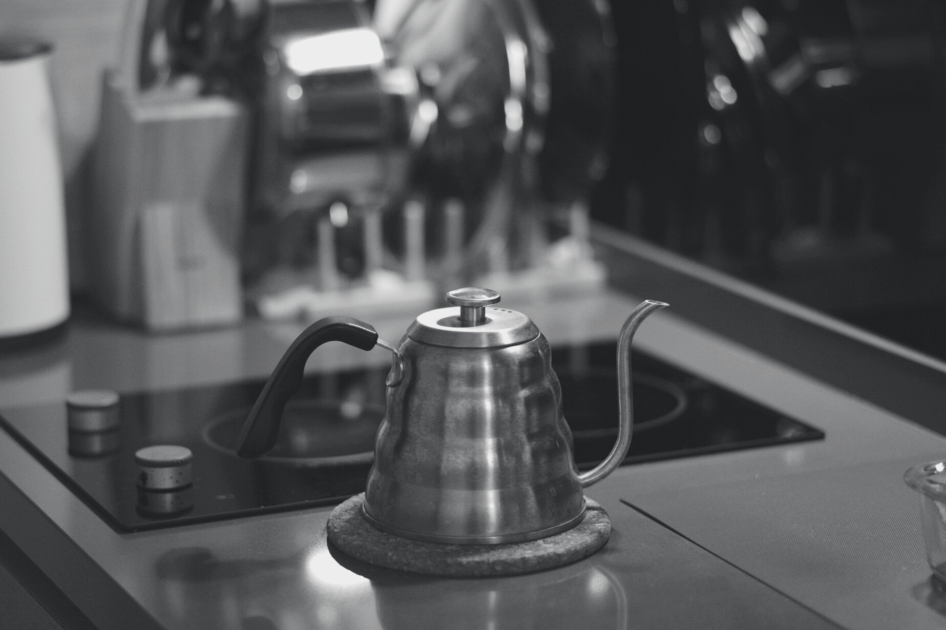 A gooseneck kettle on an induction hob